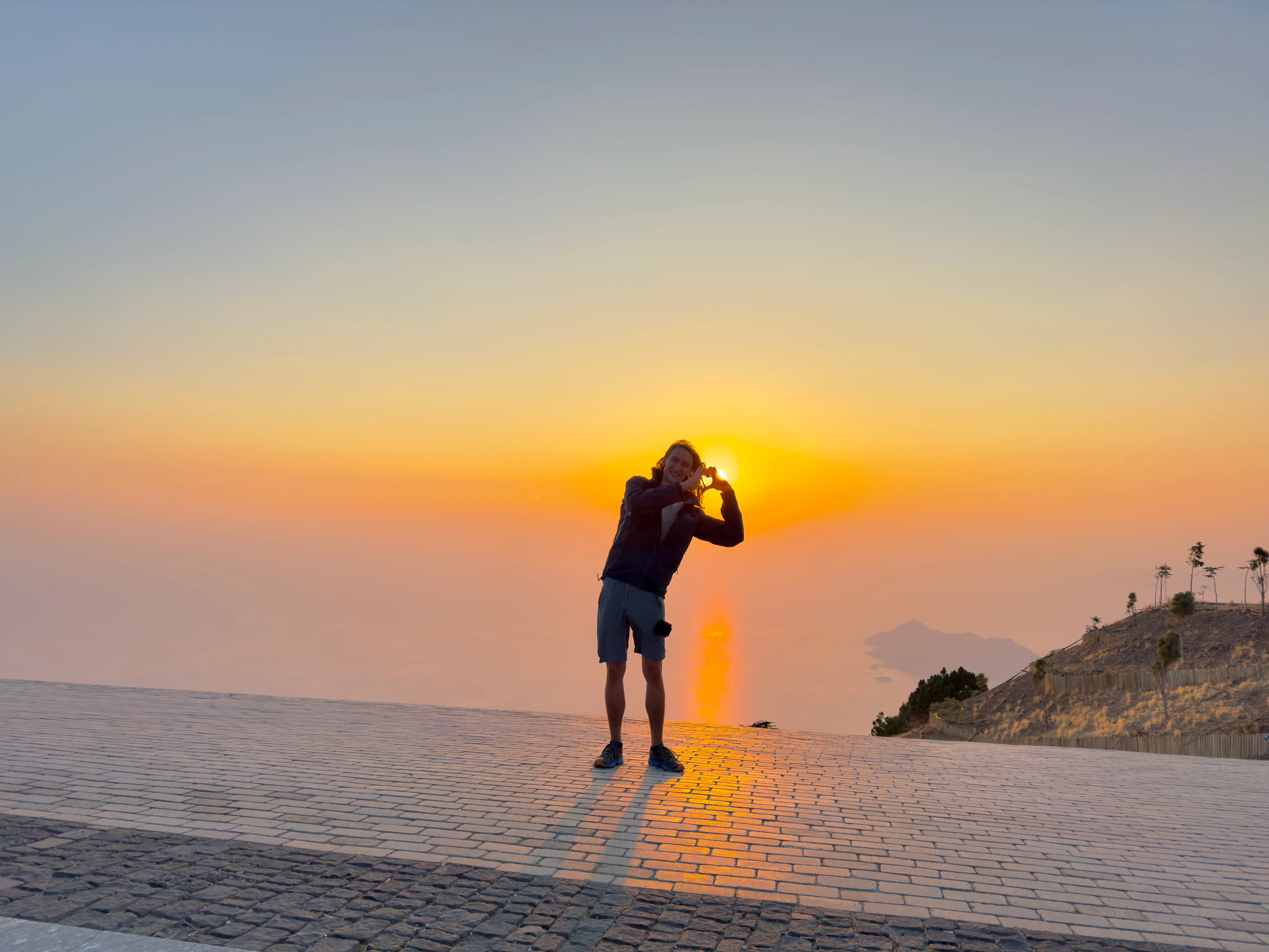 me on launch in Ölüdeniz making a heart with the sunset in the background